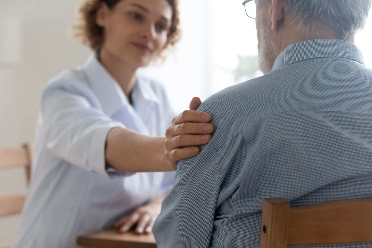 woman with hand on clients shoulder