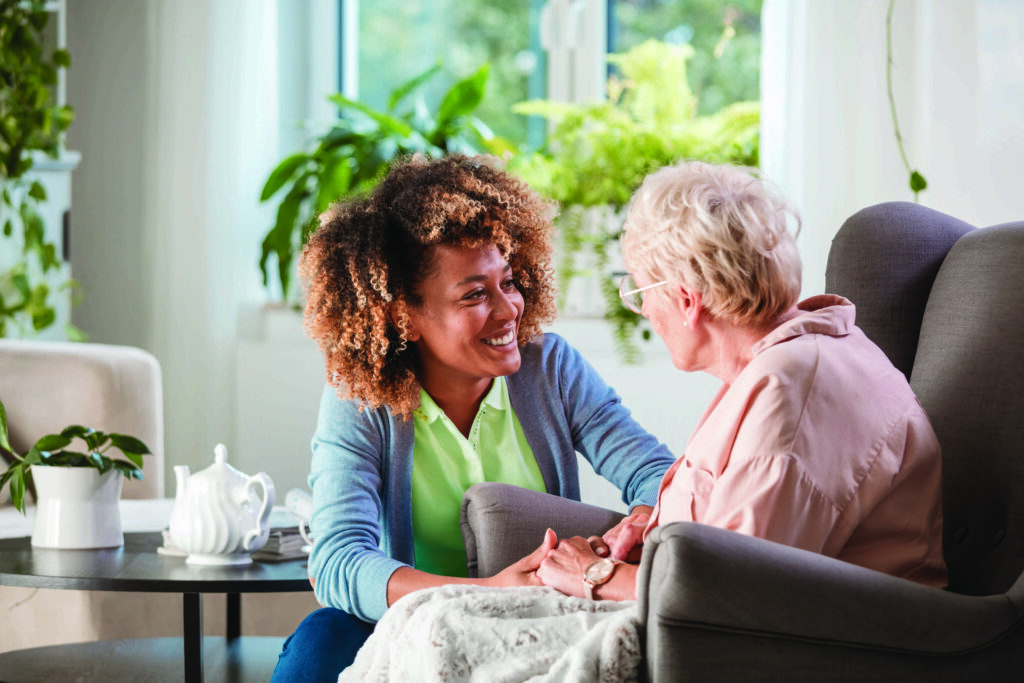 springpoint at home woman embracing senior on couch